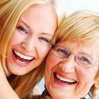 A woman and her daughter smile with confidence